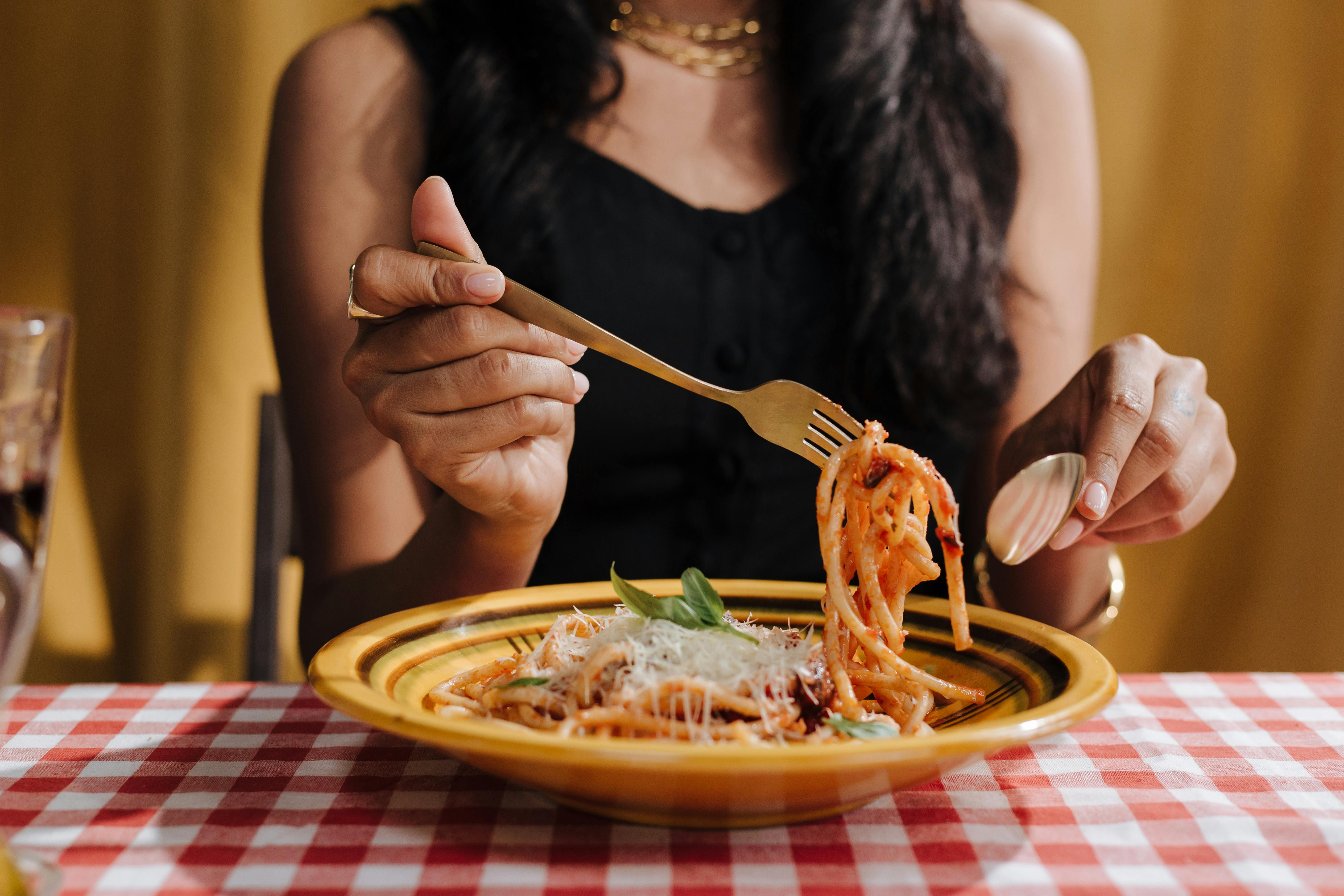 Photo by Ron Lach : https://www.pexels.com/photo/a-female-holding-a-fork-with-pasta-on-it-above-a-plate-10067945/