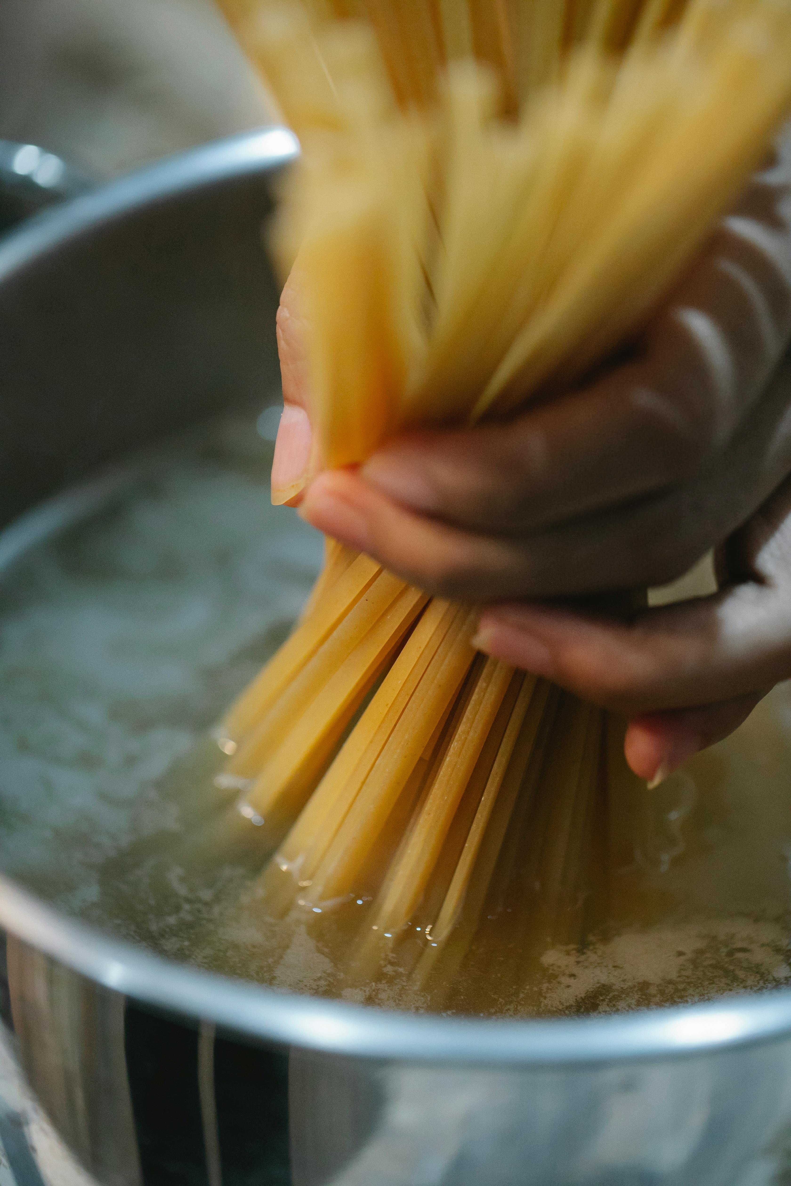 Photo by Klaus Nielsen: https://www.pexels.com/photo/woman-putting-spaghetti-in-boiling-water-6294420/
